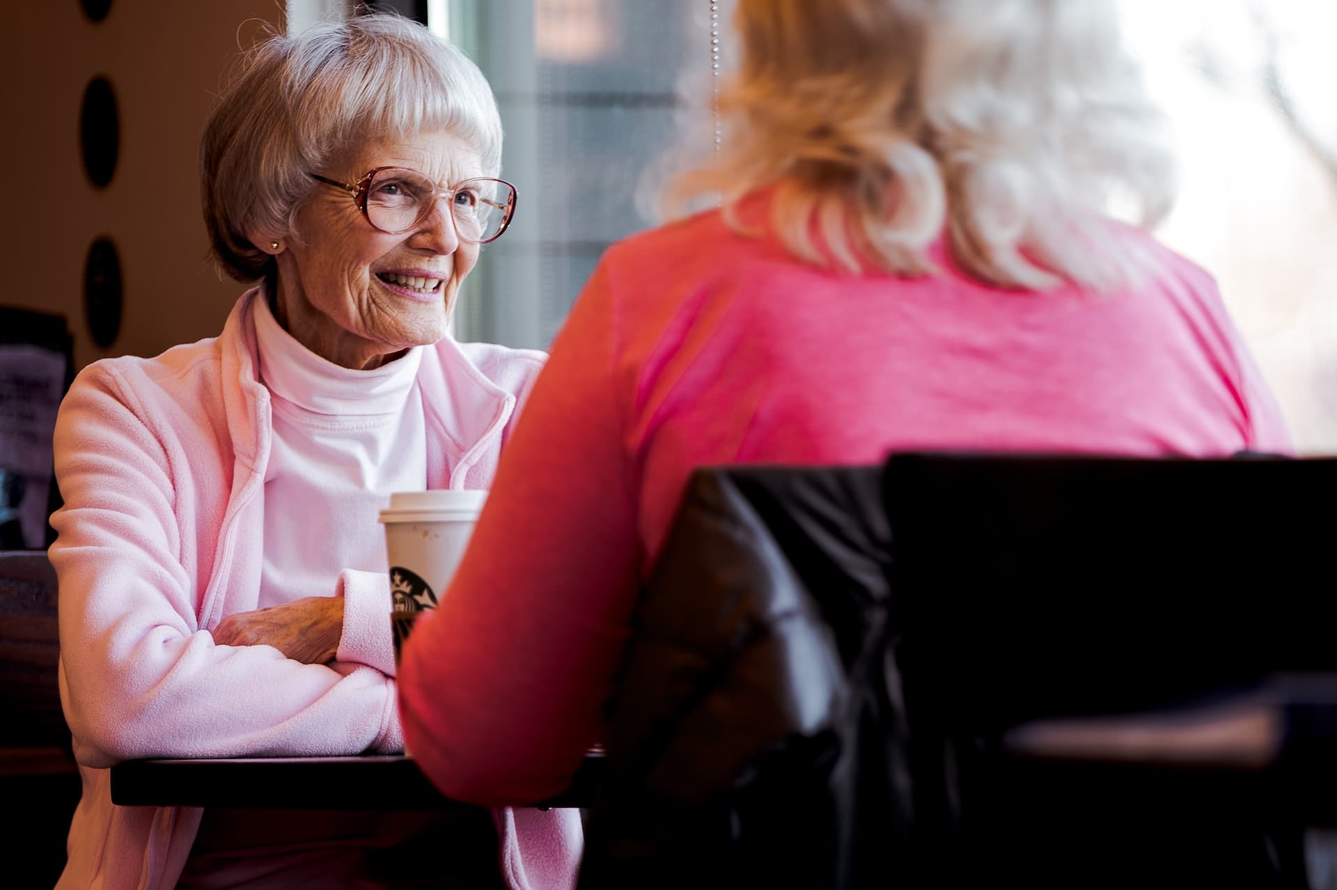 Older woman discussing in cafe